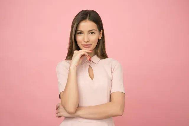 Smiling woman on pink background