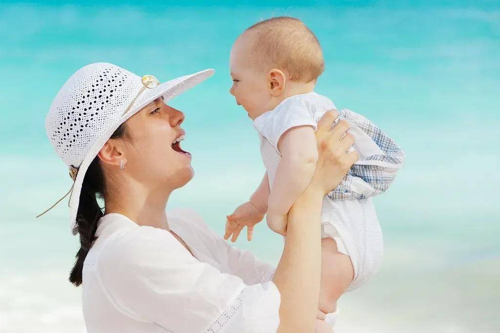 Happy mother and baby at beach